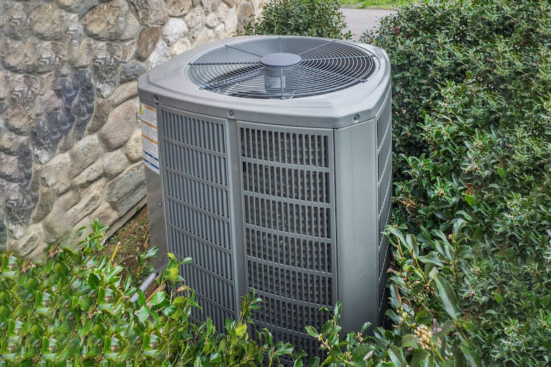 Heating and air conditioning unit in back of a residence