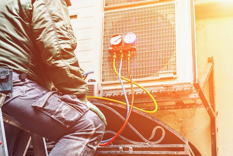 Worker working on an Air Conditioner in Hudson