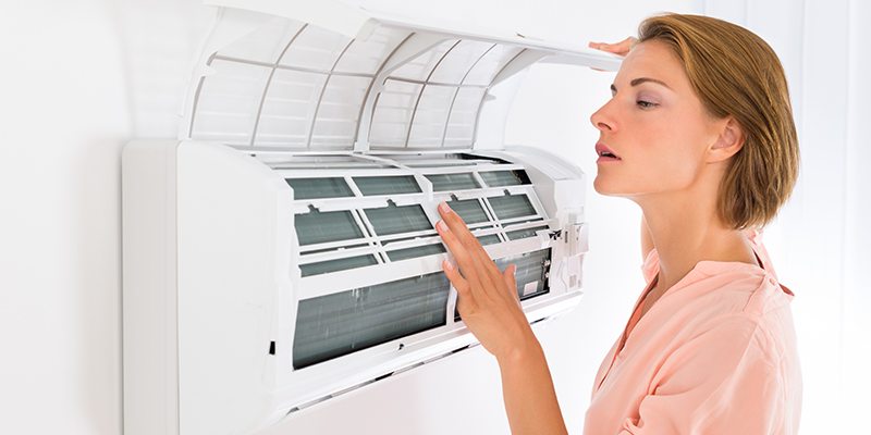 Woman checking Air Conditioner
